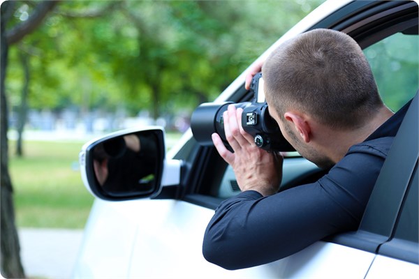 investigator capturing his target on a distance